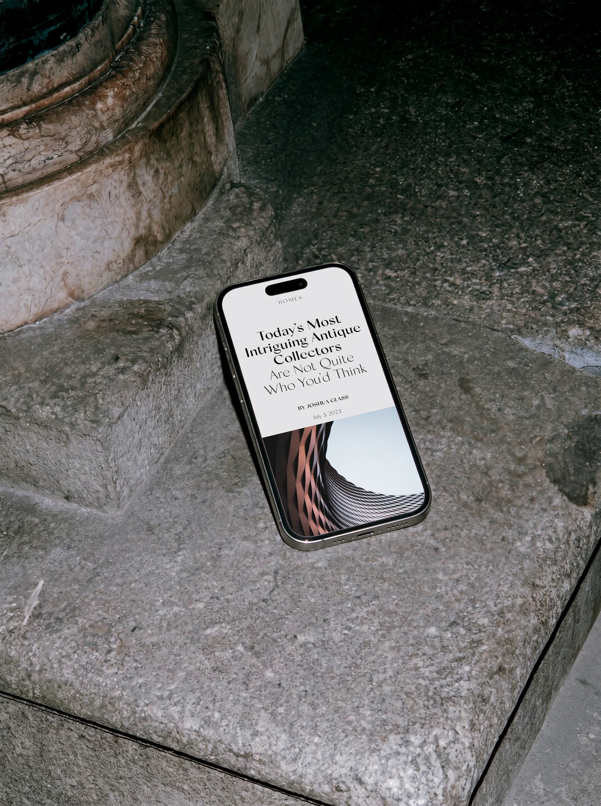 Smartphone displaying an editorial article layout using Silk Sans typography, photographed on a textured stone surface.