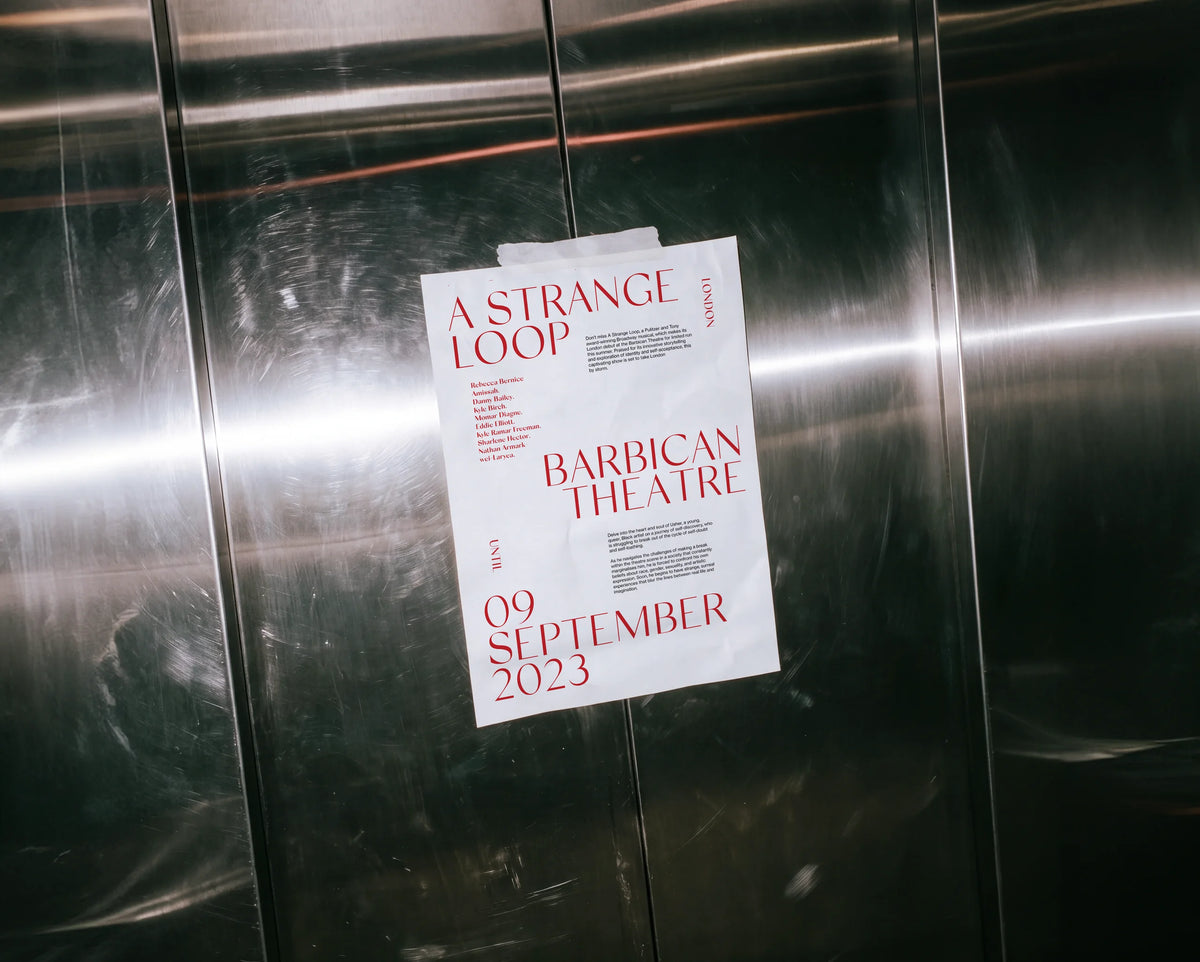 Theatre poster for A Strange Loop using Silk Sans typography, displayed on a brushed metal wall.