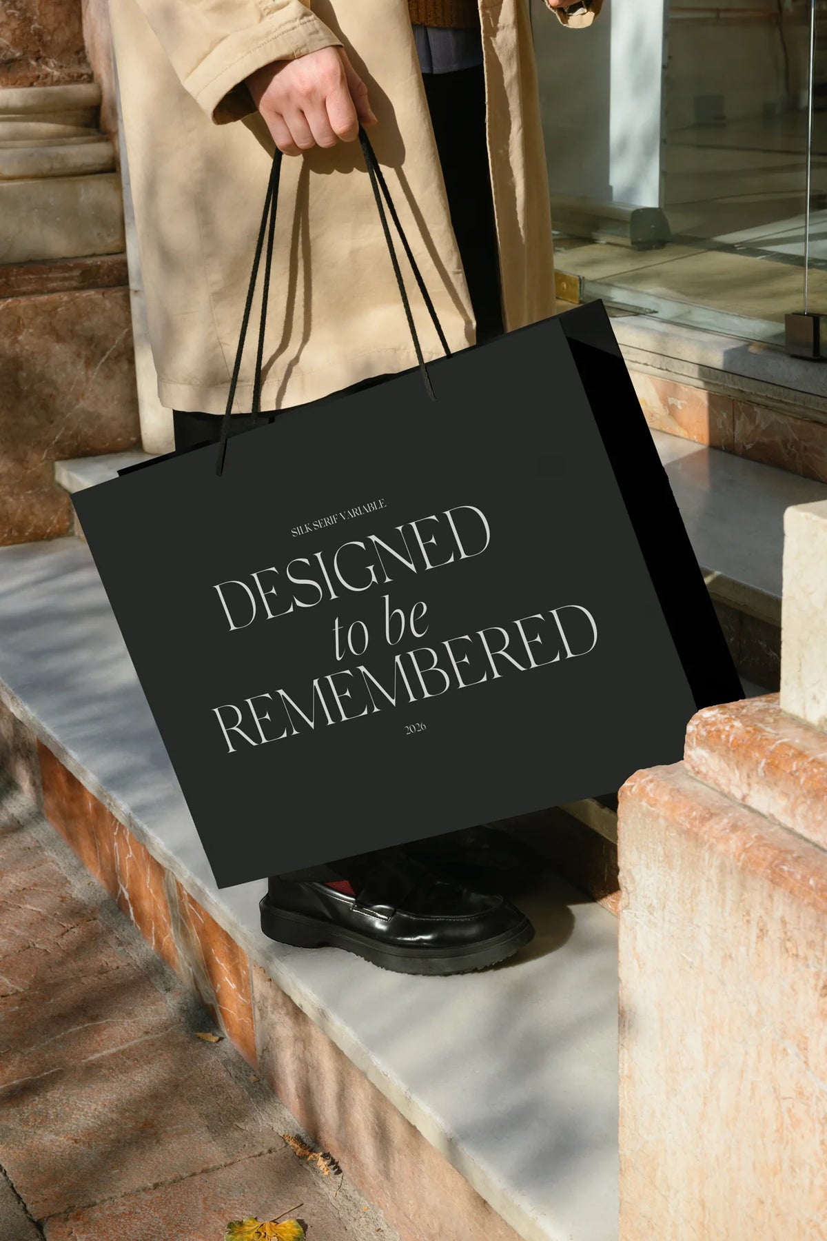 Silk Serif variable font used on a black shopping bag with elegant high-contrast typography.