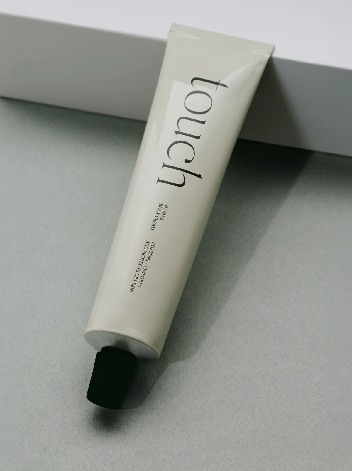 Silk Serif font used on a hand and body cream tube with clean cosmetic packaging.