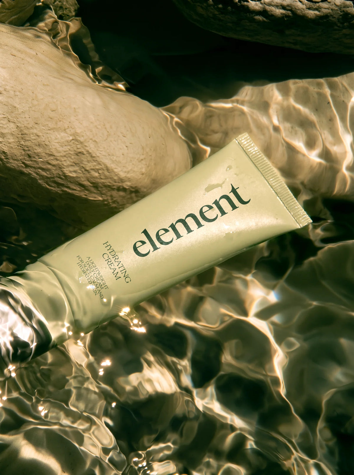 Velour font used on hydrating cream packaging with elegant serif branding in water.